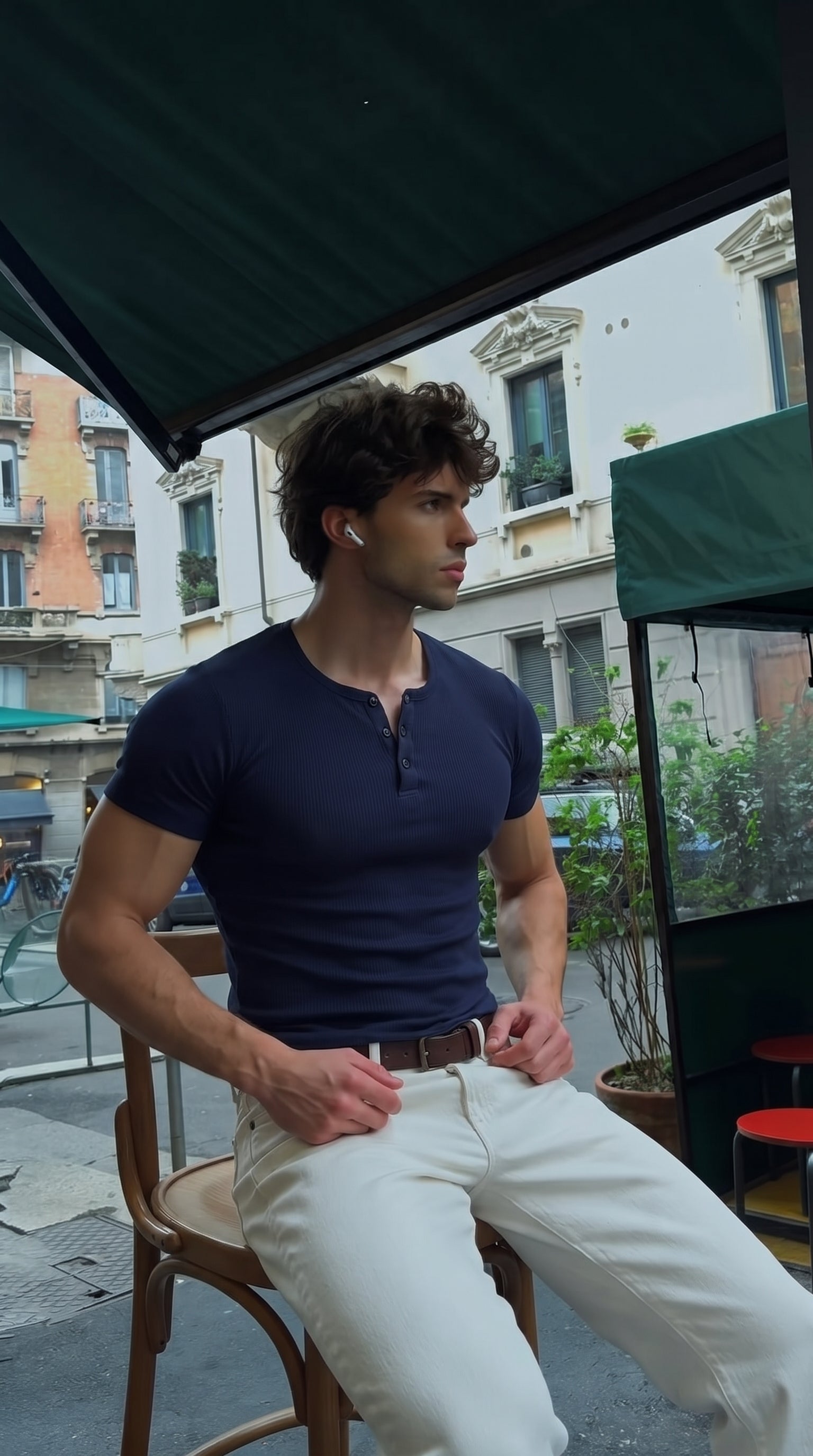 Man wearing the AURRA navy Henley at a cafe