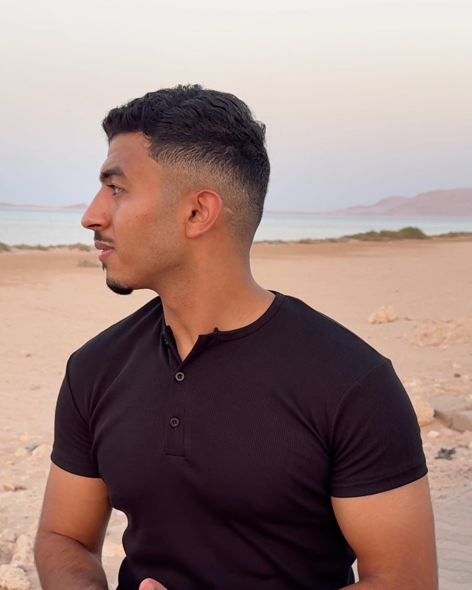 AURRA Henley in Black worn outdoors