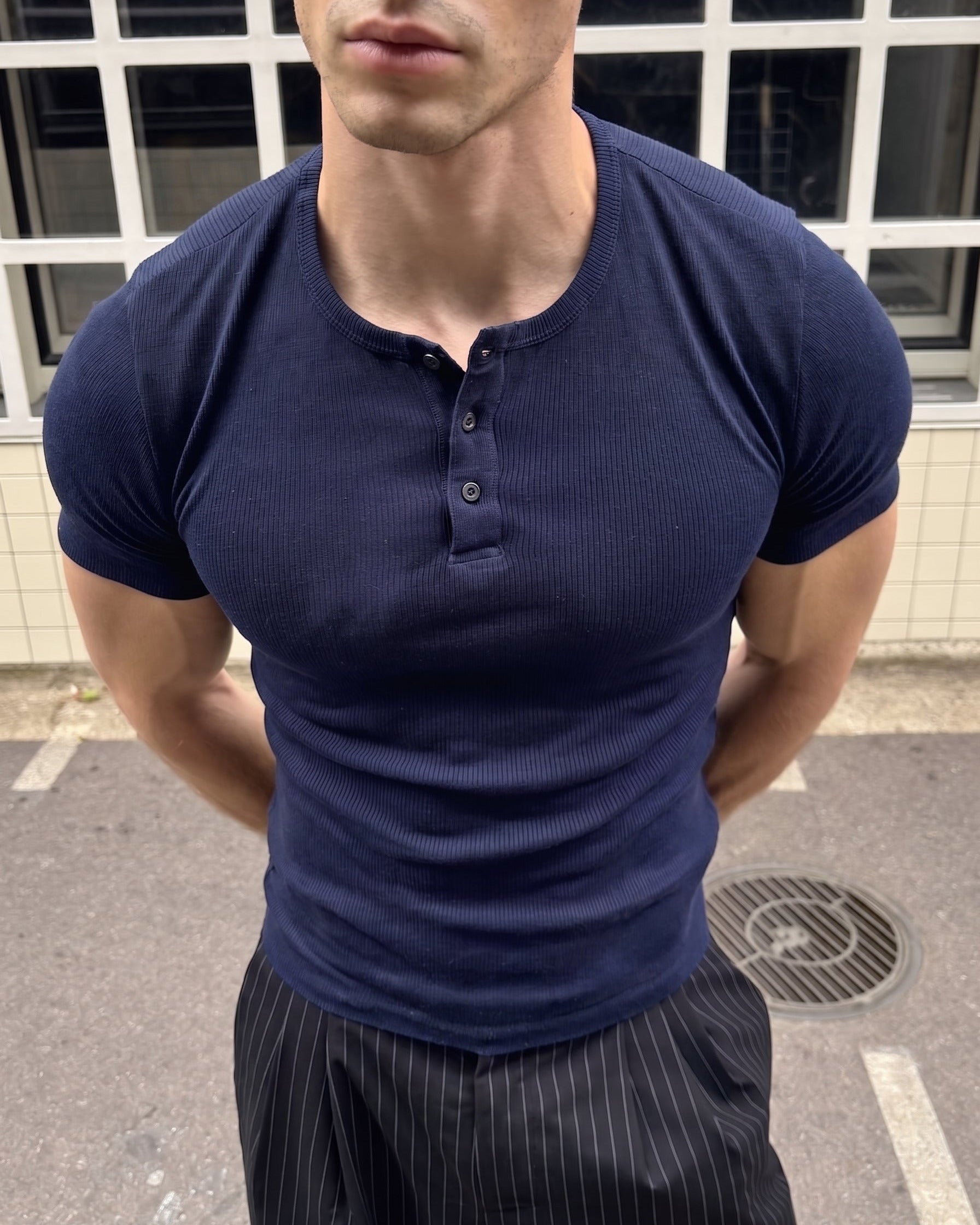 AURRA Henley in Navy — close detail of the ribbed knit and placket