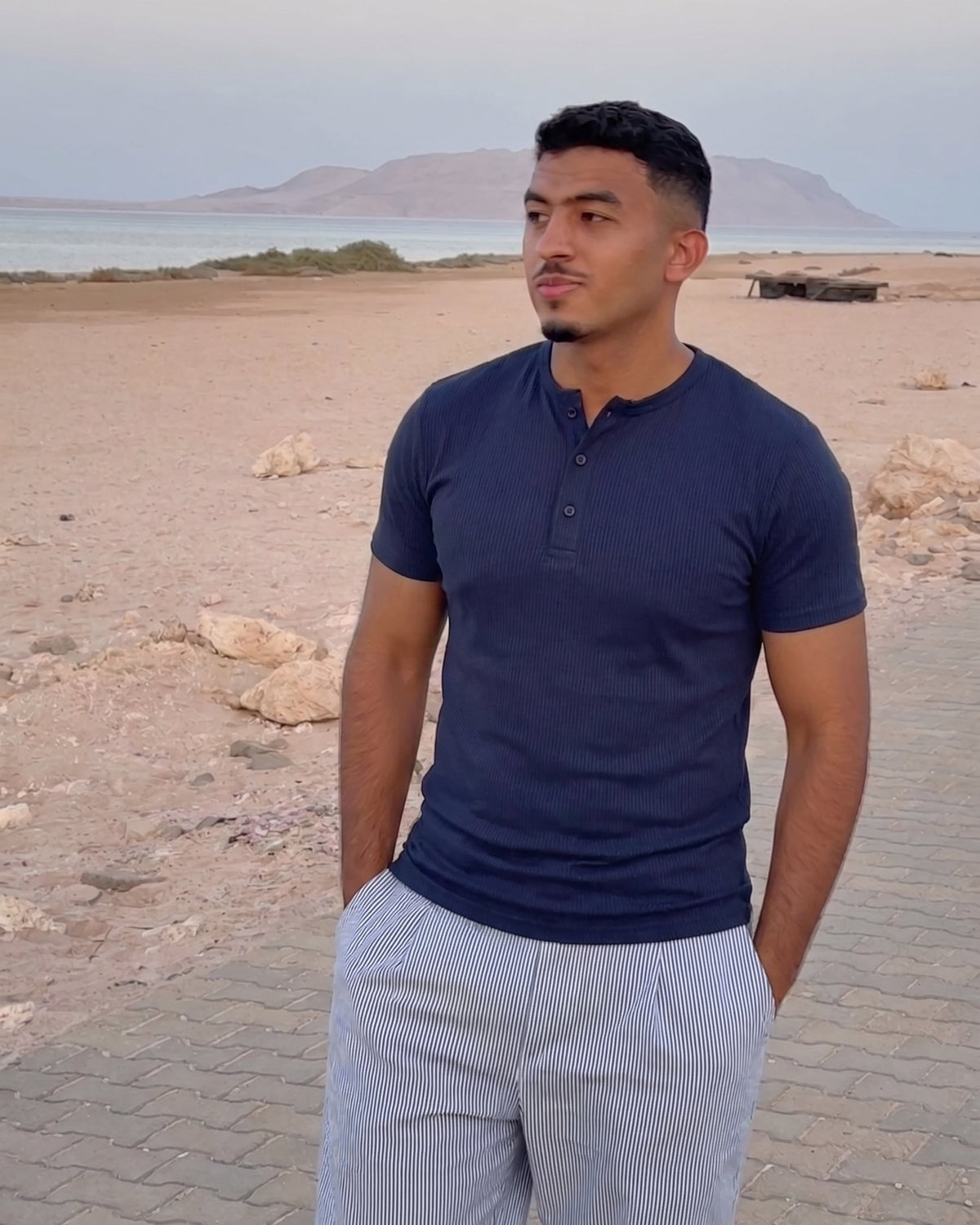 AURRA Henley in Navy worn at the coast