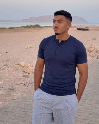 AURRA Henley in Navy worn at the coast
