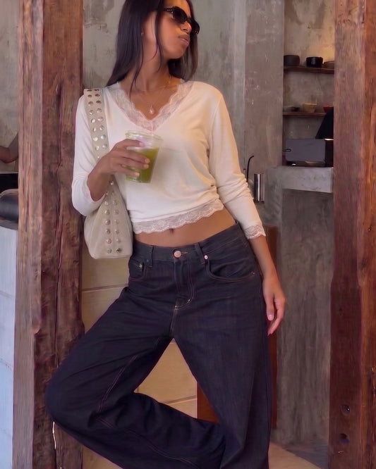 AURRA Cropped V Lace Top in off-white, worn with dark wide-leg jeans